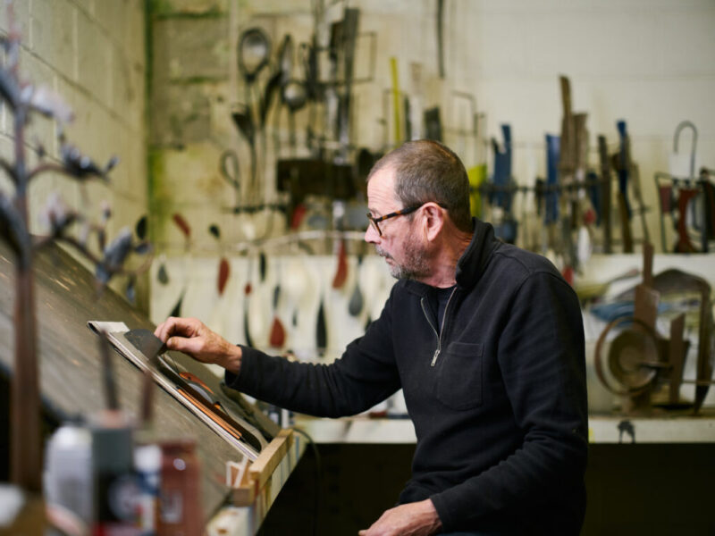 Brian Fell and George Fell working in the workshop together with elephant sculpture in background